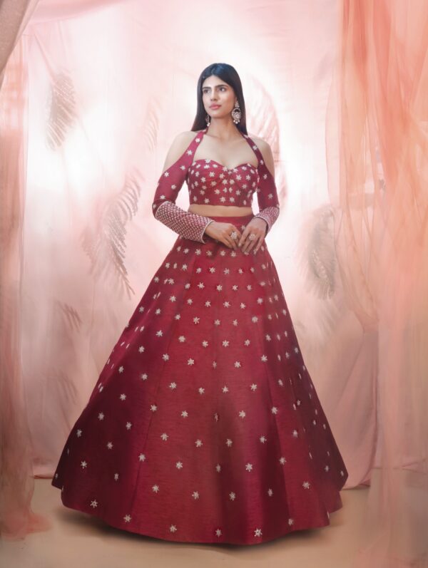 PINK PEACOCK COUTURE – Cranberry lehenga with a corset style blouse