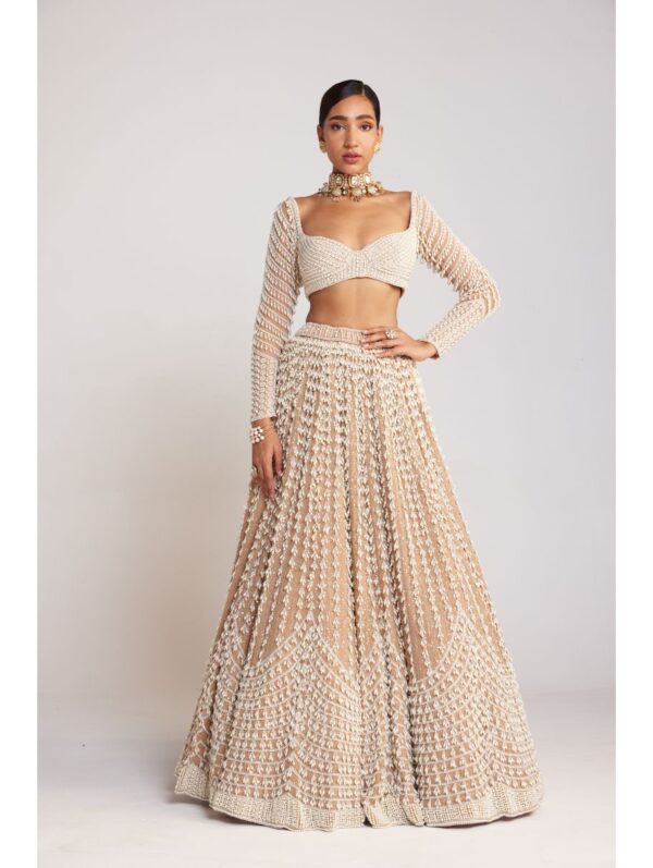 Vvani Vats - Beige chandelier pearl lehenga paired with full sleeve pearl drop blouse.
