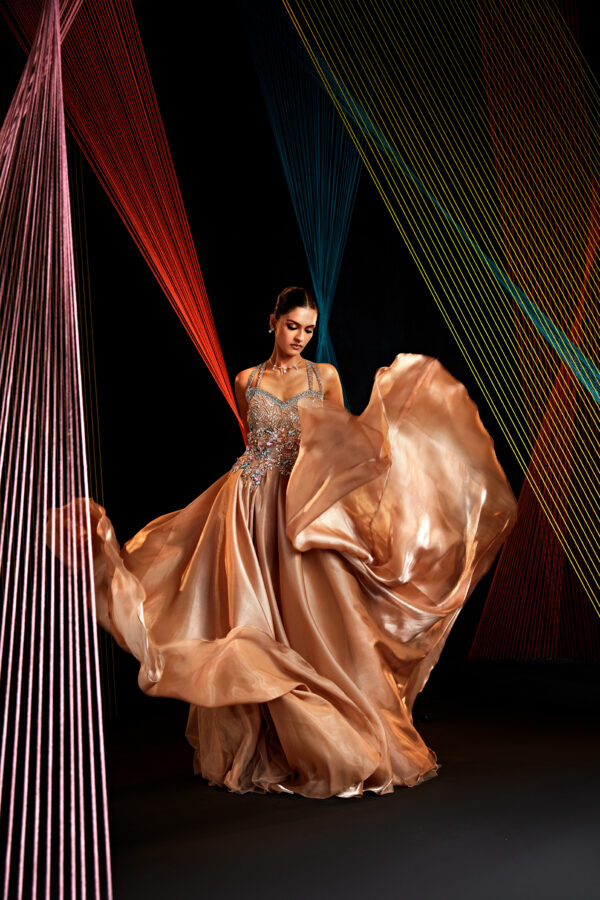 Roqa - Straight falling gown in a champagne gold color